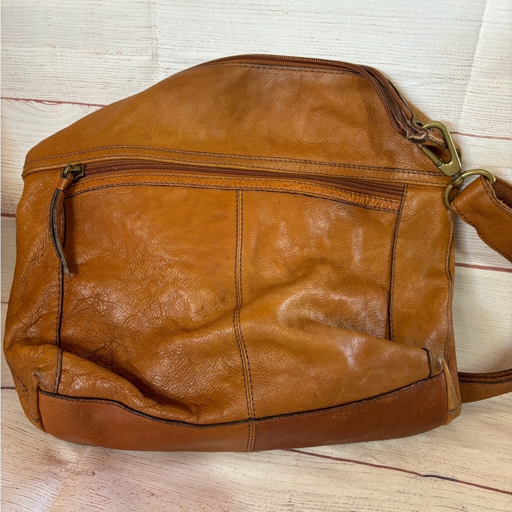 Fossil shoulder bag. All 3 zippers work. Strap has rough area included picture